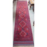 A red and blue ground Eastern runner with geometric design, 240cm x 60cm Condition Report: Available