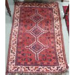 A red ground Eastern rug, 126cm x 84cm Condition Report: Available upon request