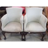 A pair of green upholstered carved mahogany chairs with ball and claw feet (2) Condition Report: