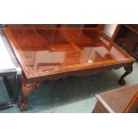 A large reproduction mahogany coffee table with ball and claw feet Condition Report: