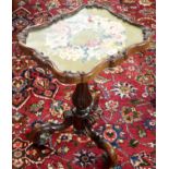 A carved mahogany occasional table with tapestry inset on carved tripod base Condition Report: