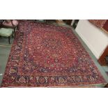 A red ground Keshan rug with central medallion, 377cm x 287cm Condition Report: Available upon