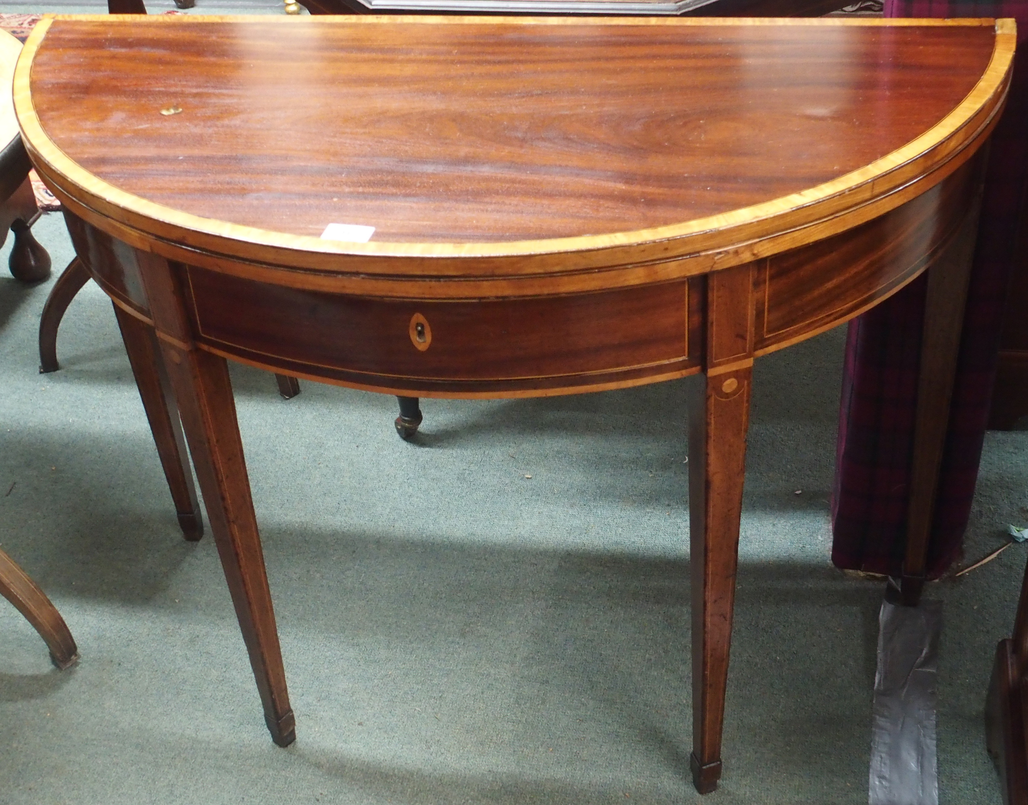 An inlaid mahogany fold over tea table Condition Report: Available upon request