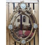 A large gilt wall mirror with resin cherub decorations Condition Report: Available upon request