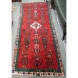 A red ground Eastern runner, 248cm x 92cm Condition Report: Available upon request