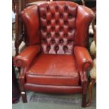 A red leather Chesterfield wing back chair Condition Report: Available upon request