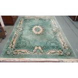 A very large green wool rug, (def) 276cm x 376cm Condition Report: Available upon request