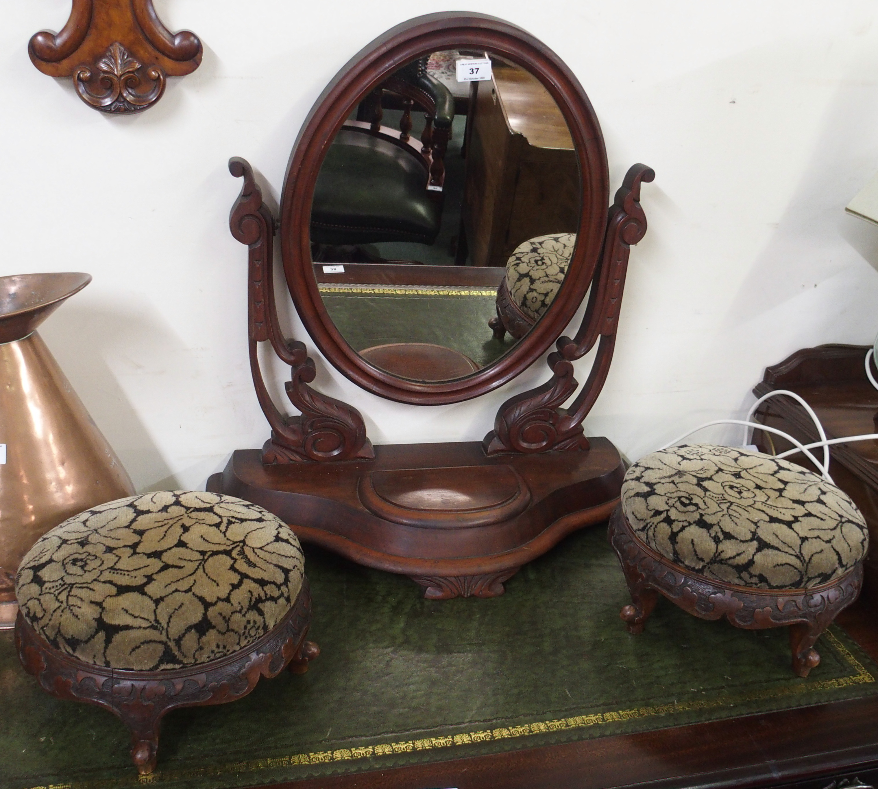 A pair of Victorian walnut carved footstools and a mahogany toilet mirror (3) Condition Report: