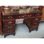 A reproduction mahogany twin pedestal desk with green leather skiver, 77cm high x 122cm wide