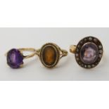 A 9ct Irish gold amethyst set ring size K and a further amethyst and pearl ring and a citrine