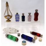 A collection of double end scent bottles and other scent and smelling salt bottles, including a