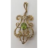A 9ct gold Edwardian pendant brooch in the shape of a harp set with a peridot and pearls, dimensions