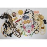 A collection of vintage costume jewellery to include a Poole Pottery dolphin brooch, mother of pearl