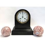A dome top black slate mantle clock and two red and white pottery carpet bowls Condition Report: