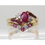 A 9ct gold ruby and diamond cluster ring, size P, together with a 9ct ruby and cz 'V' shaped ring