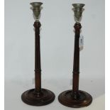 A pair of turned wood candle sticks, 39cm high Condition Report: Available upon request