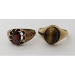 A 9ct rose gold garnet set ring size S1/2 and a 9ct gold tigers eye set ring size Q, weight combined