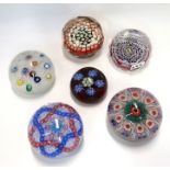 A French Baccarat glass paperweight with Millefiori patterns on upset muslin ground, dated 1971 with
