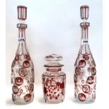 A pair of ruby flashed and cut glass decanters, together with a lidded jar Condition Report: