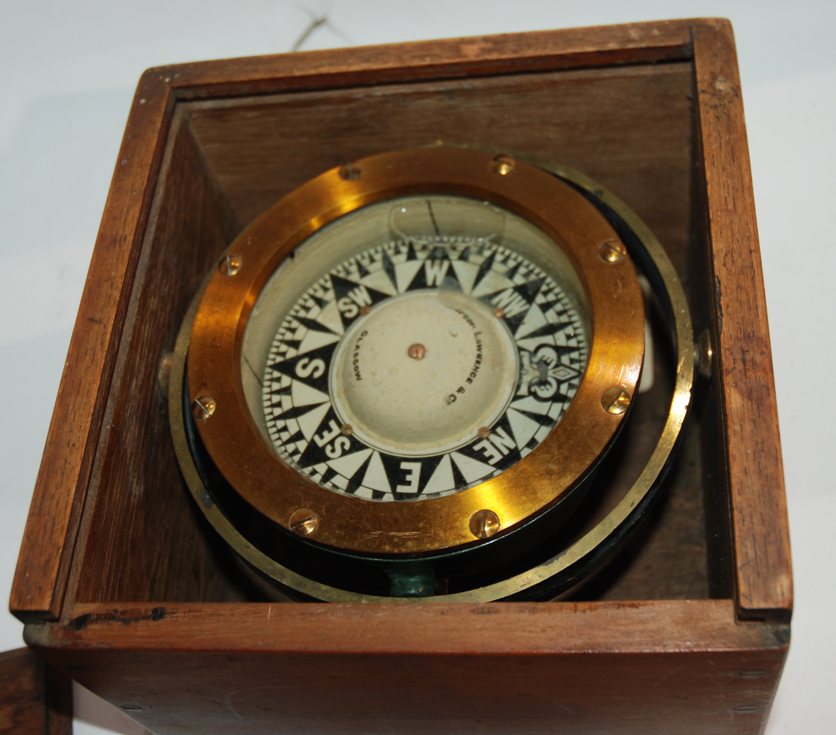 A cased compass by Joseph Lawerence & Co, Glasgow Condition Report: Available upon request