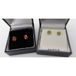 A pair of 9ct padparadscha colour sapphire earrings, and a pair of 9ct peridot earrings weight