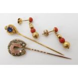 A 9ct gold blue gem set pin, together with a gem set horseshoe example and a pair of coral