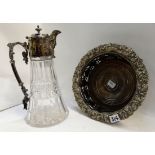 A lot comprising a silver plated mounted claret jug and a wine coaster Condition Report: Available