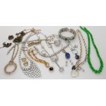 A silver chain with heart pendants, silver gem set pendants, Chinese green hardstone beads etc