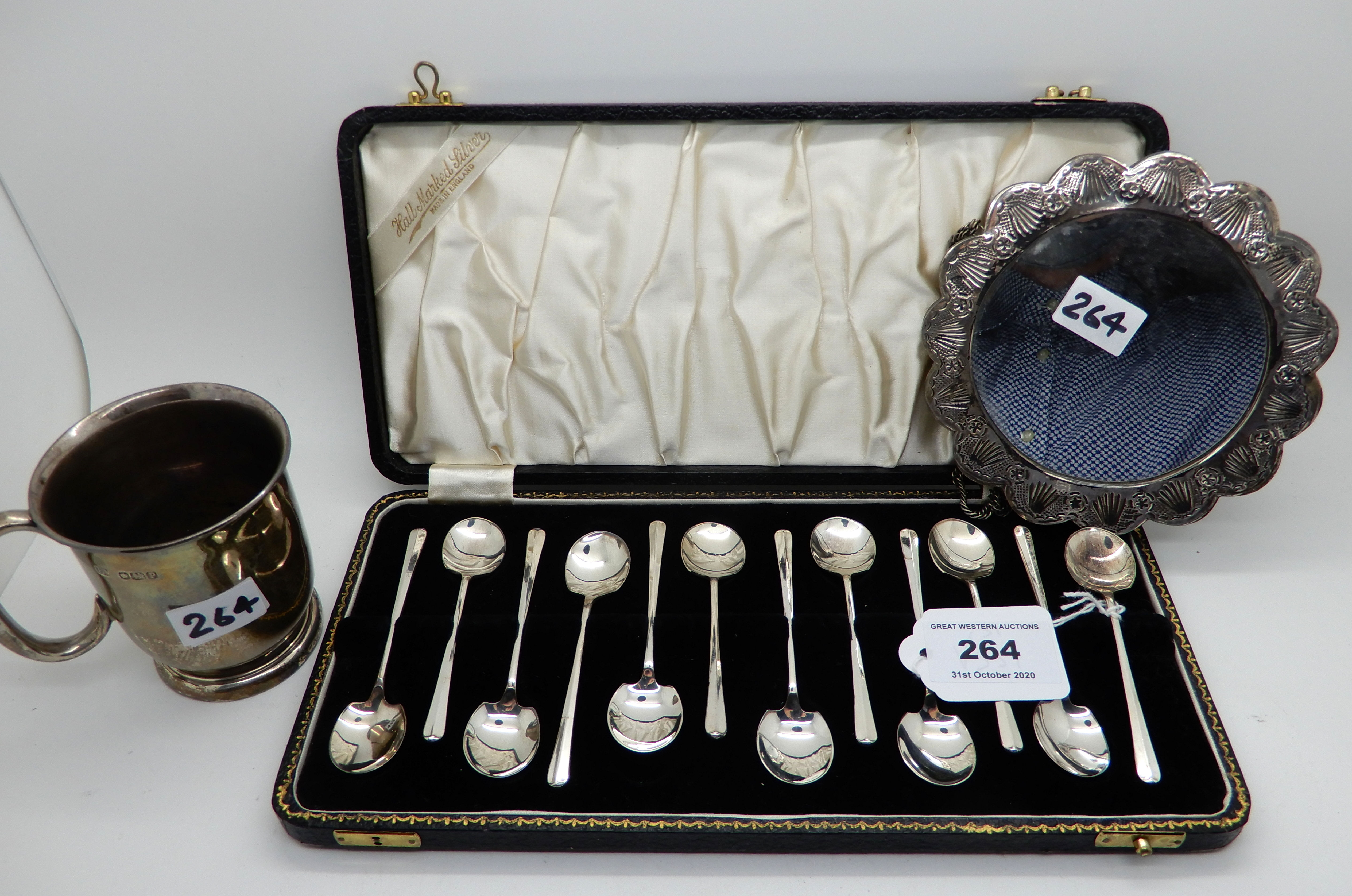 A lot comprising a cased set of twelve coffee spoon, a silver christening mug and a white metal