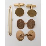 A pair of 9ct gold cufflinks engraved with the WRNS insignia, a further pair of 9ct cufflinks and