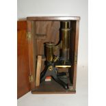 A brass microscope in fitted case and two boxes of slides Condition Report: Available upon request