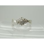 A 9ct white gold diamond cluster ring set with estimated approx 0.25cts (three diamonds missing)