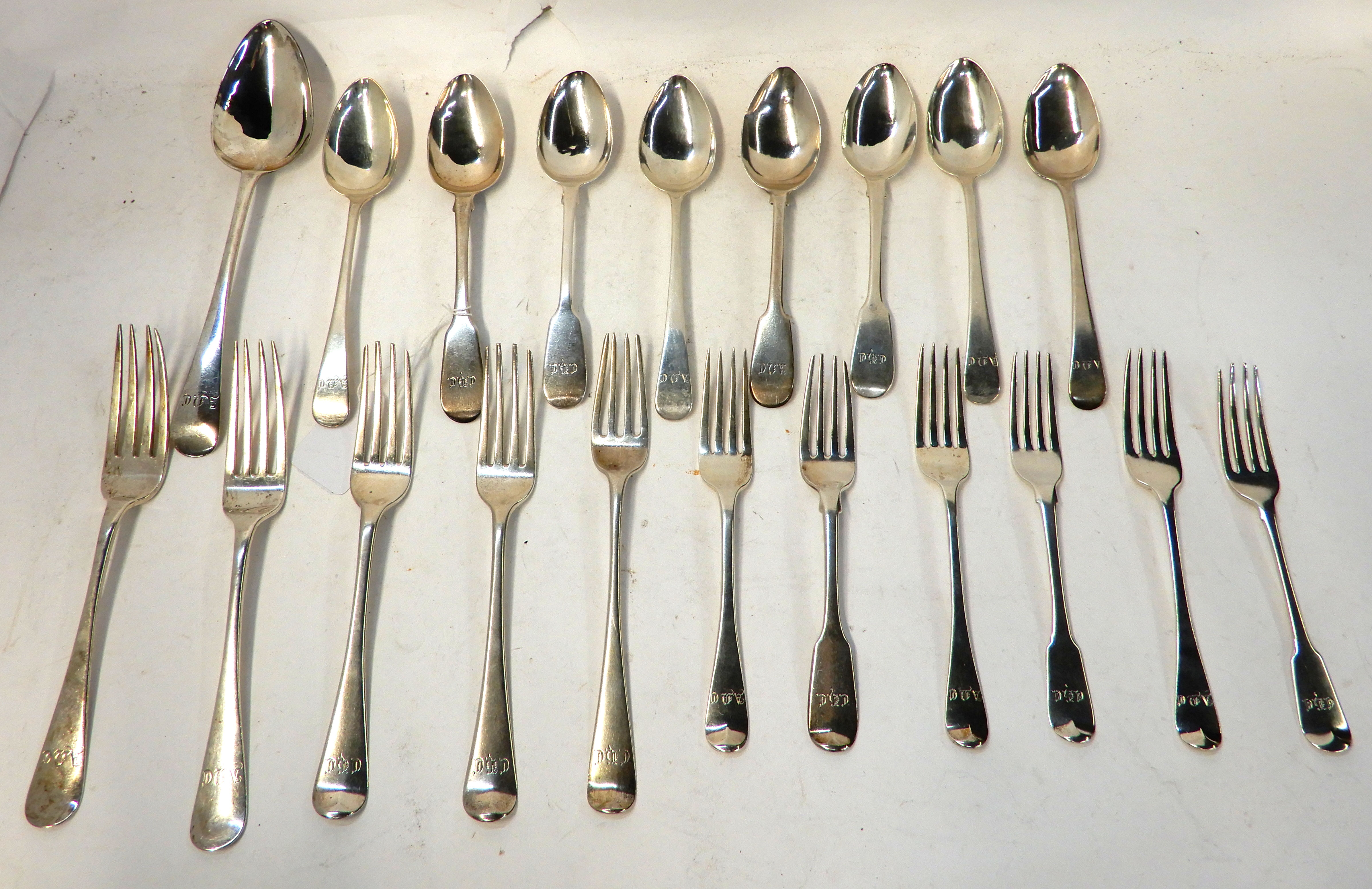 A lot comprising twenty assorted silver spoons and forks, 919gms Condition Report: Available upon