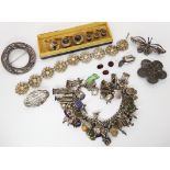 A set of yellow and white metal garnet shirt studs, an extensive charm bracelet and other items