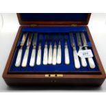 A cased twenty four piece silver and mother of pearl dessert cutlery set, Sheffield 1914 with four