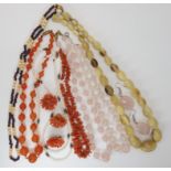 Strings of rose quartz, carnelian, horn and coral beads with matching coral brooch and earrings