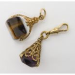 A 9ct gold decorative fob seal set with tigers eye, together with a yellow metal example set with