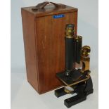 A brass and lacquered black microscope by James Parkes & Sons, Birmingham in fitted case Condition