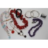 A coral bead necklace, amethyst beads, silver bangles and other items of silver and white metal