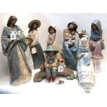 Four Lladro figures including a boy and puppy on a bridge fishing, girl sitting beside sparrows,