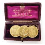 A pair of 1887 shield back half sovereigns and a 1897 half sovereign fashioned into a brooch with