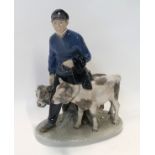 A Royal Copenhagen figure of a farmer with two calves, modelled by Christian Thomsen Condition