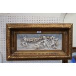 An alabaster style classical plaque depicting cherubs, within a gilt frame, 70cm x 39cm Condition