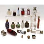 A collection of scent phials, silver topped cut glass scent bottles and smelling salt bottles