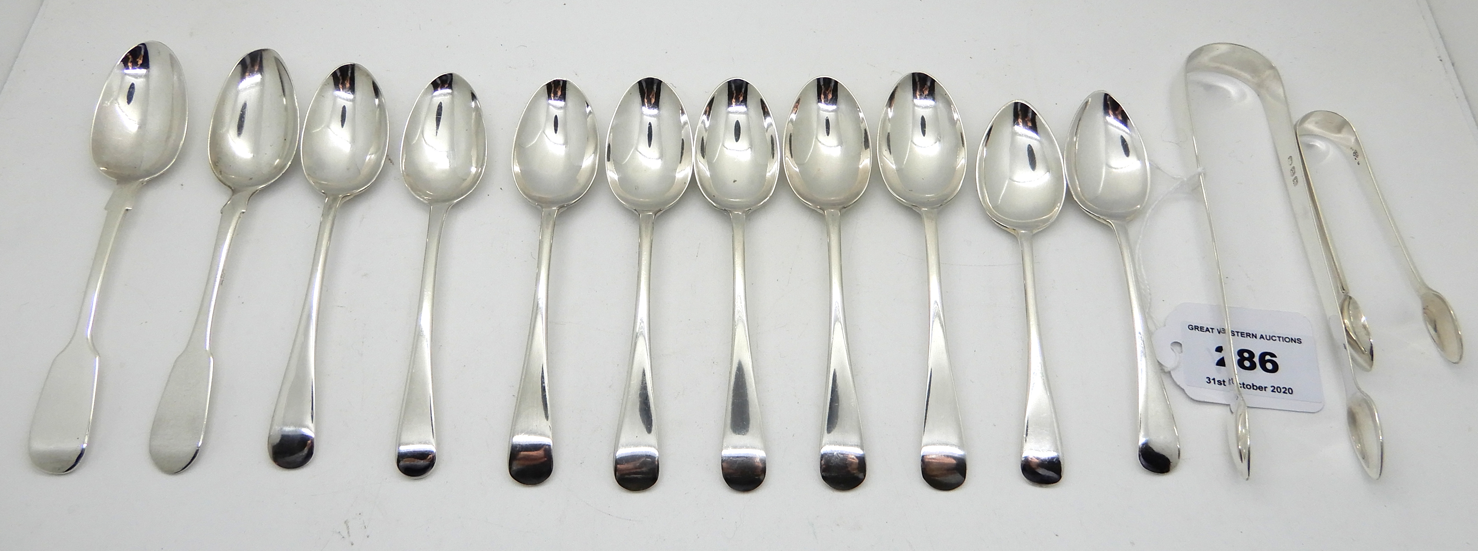 A lot comprising eleven assorted teaspoons, various marks and makers and two pairs of silver sugar