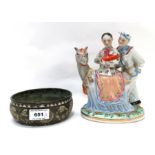 A Persian brass bowl with enamel decoration and a Chinese figure of a couple with a baby and a horse