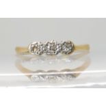 An 18ct gold three stone diamond ring, size M1/2, 1.9gms Condition Report: Available upon request