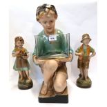 A large painted plaster figure of a kneeling boy and a pair of smaller plaster figures Condition