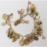 A 9ct gold charm bracelet, with twenty one 9ct gold and yellow metal charms to include a squirrel,