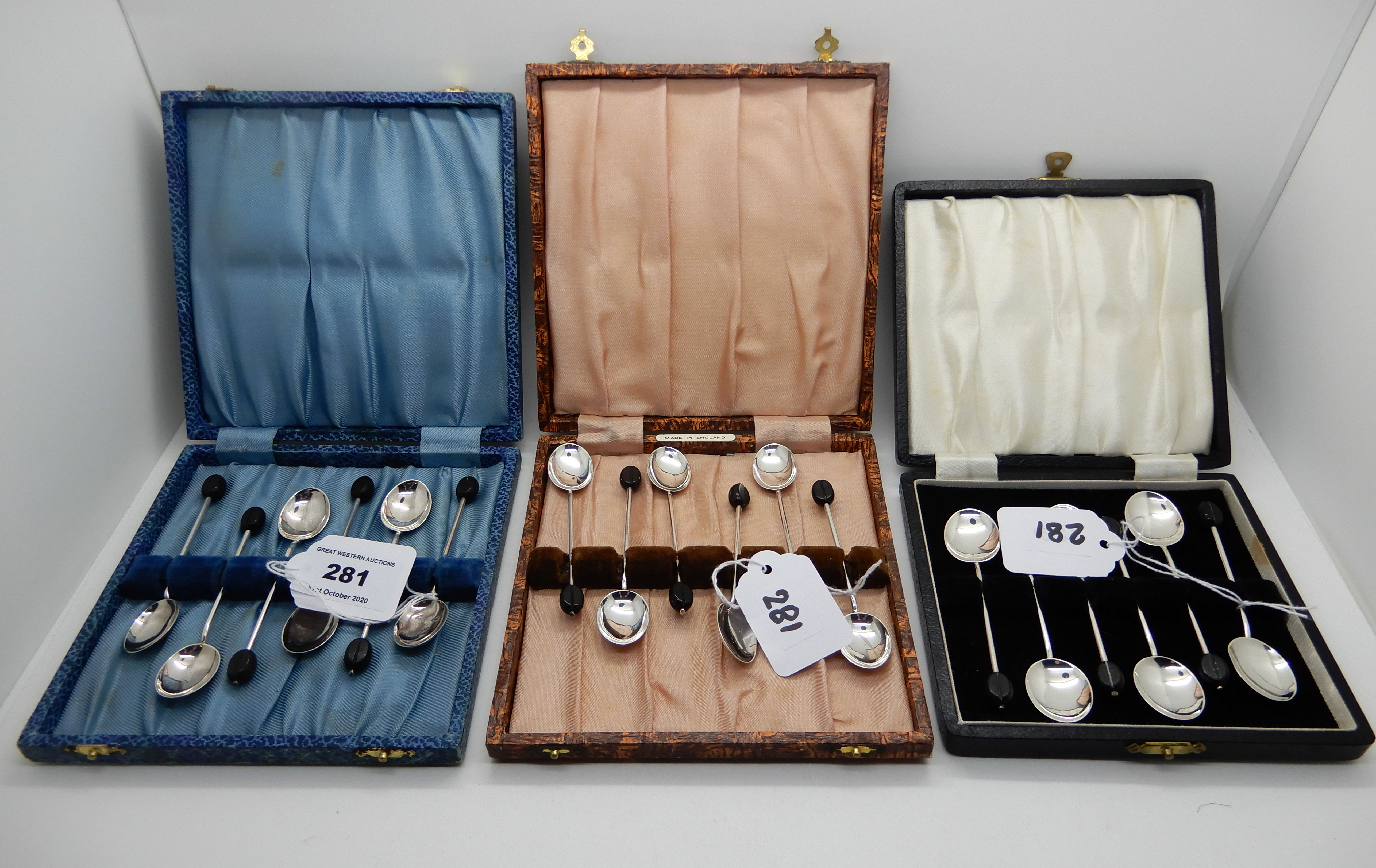 A lot comprising three cased sets of silver coffee bean spoons, Birmingham 1923, 1924 and 1938